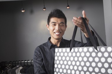 happy asian male retail staff
